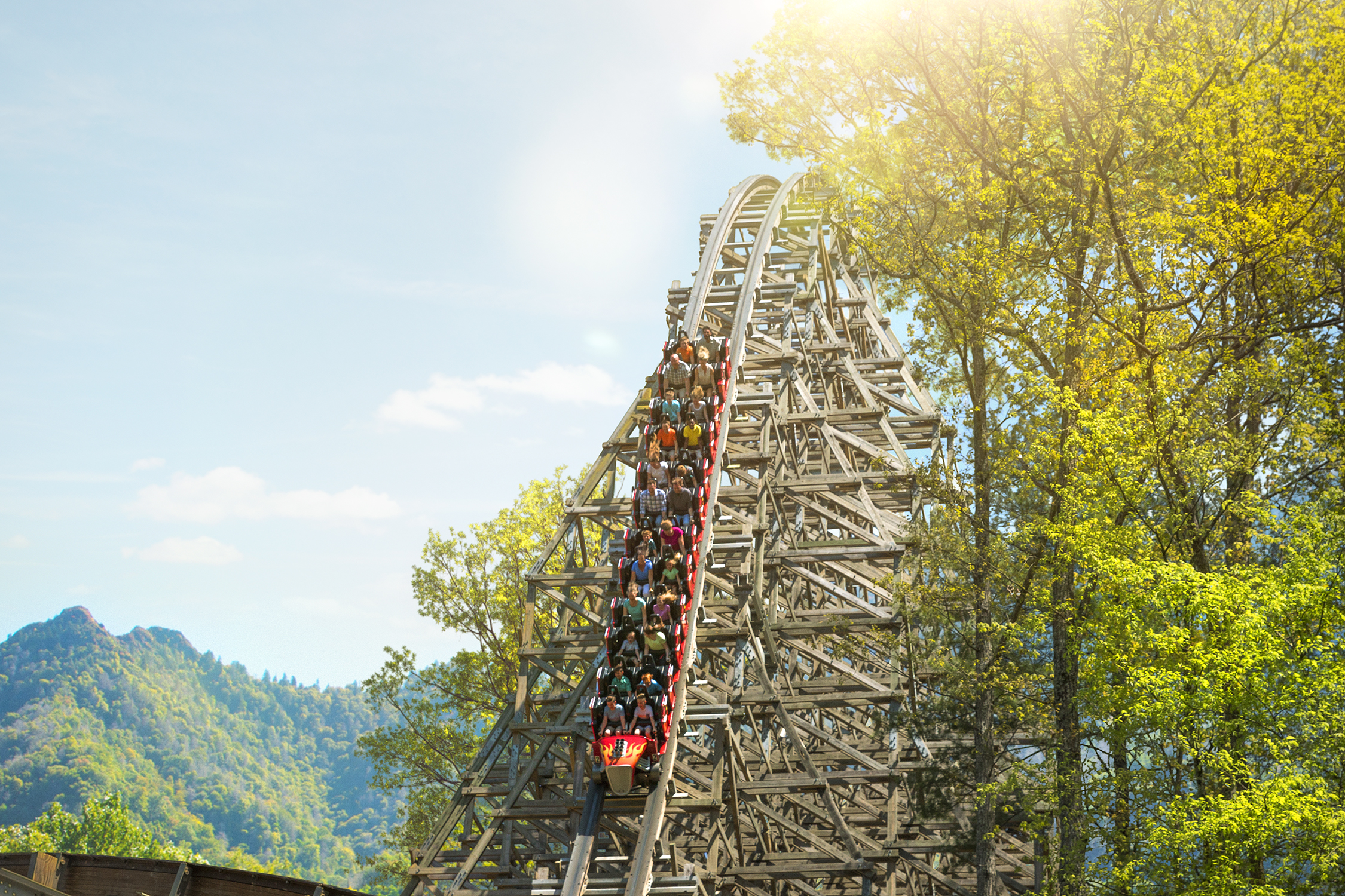 Guests enjoying a thrilling roller coaster ride at Dollywood Theme Park in Pigeon Forge, Tennessee, where guests staying at Xplorie participating properties can enjoy a free one-day ticket.